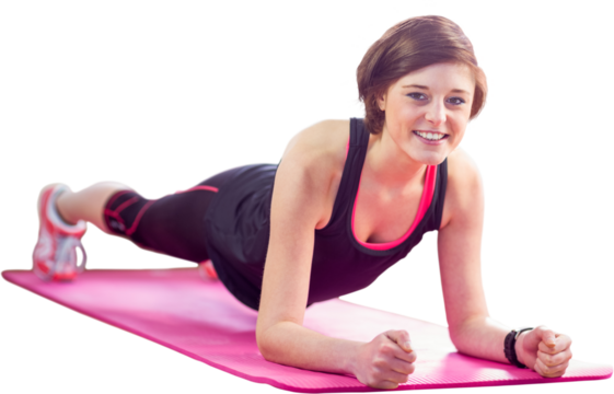 Portrait of happy woman doing plank on exercise mat