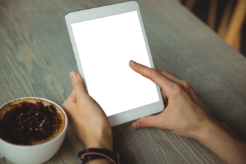 Cropped hand of woman using tablet