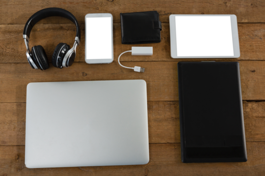 Various electronic gadgets on wooden plank - Powered by Adobe