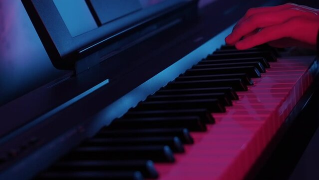 Close-up of a woman's hands playing modern piano, cinematic. neon dark key