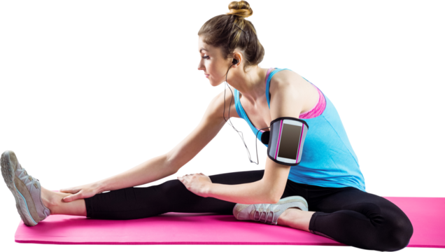 Young woman stretching on exercise mat