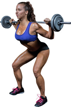 Fototapeta Woman crouching while lifting crossfit