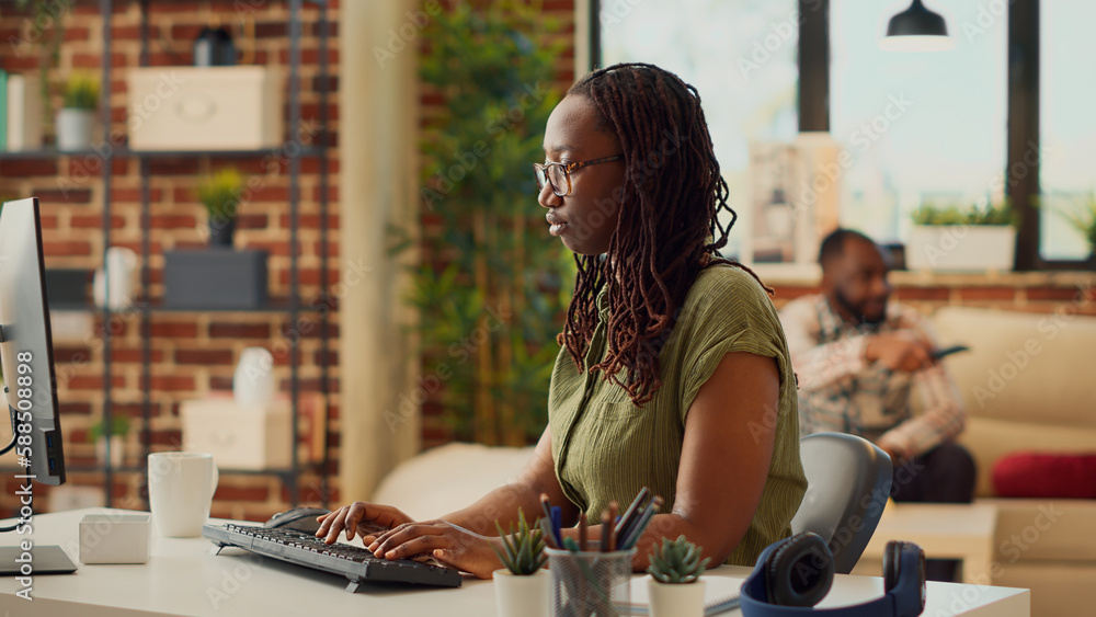 Poster office employee using computer to work on company report, sending email and creating financial web d