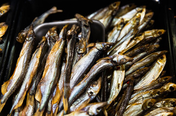 Traditional Russian appetizer. Appetizing cold smoked fish for sale on store counter