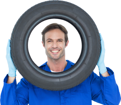 Confident mechanic looking through tire