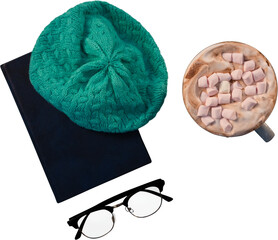 Woolly hat on diary and coffee with marshmallow