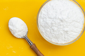 Baking soda on yellow background.