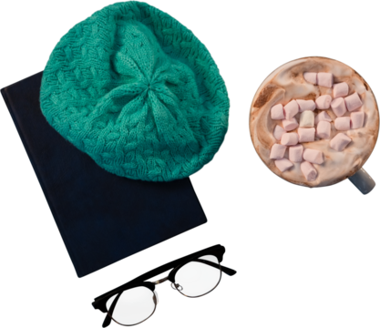 Woolly hat on diary and coffee with marshmallow