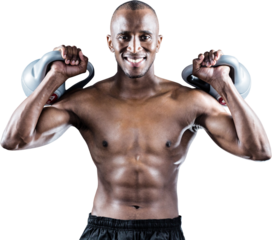 Portrait of happy muscular man exercising with kettlebells