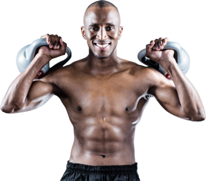 Portrait of happy muscular man exercising with kettlebells