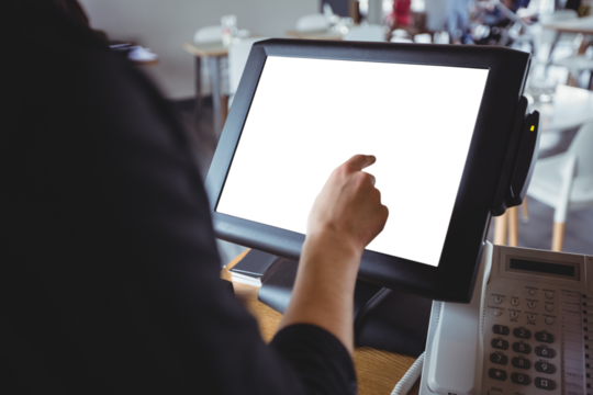 Waitress using cash register at counter