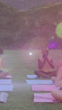 Animation of lights over diverse pupils practicing yoga outdoors