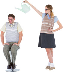 Geeky hipster holding watering can above her boyfriend