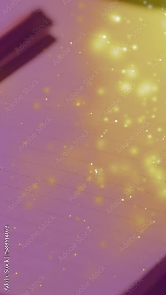Poster animation of sparkles over notepad and pen