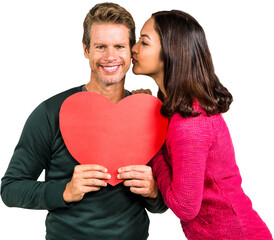 Woman kissing boyfriend with red heart shape 