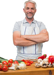 Portrait of a mature man with vegetables in kitchen