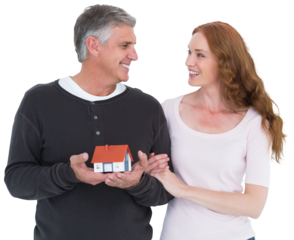 Casual couple holding small house