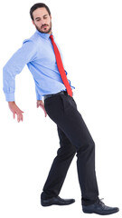 Focused businessman standing and pushing with hands