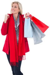 Blonde in winter clothes holding shopping bags