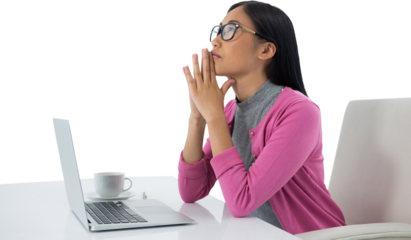 Thoughtful female executive with laptop looking up