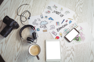 Various technologies with colorful charts and coffee on table