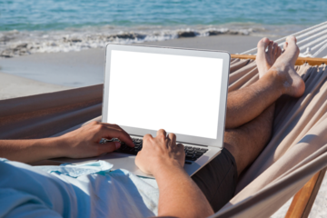 Man using laptop while relaxing on hammock