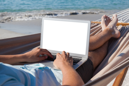 Man using laptop while relaxing on hammock