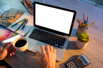 Cropped hands of male executive working over laptop at desk