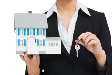 Businesswoman in suit holding a model house and key