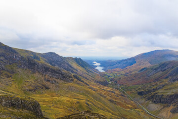 Obraz premium cloudy sky over beautiful Snowdonia, Llyn Peris Lake in the background, traveling in Wales, UK. High quality photo