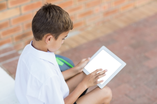 Boy using digital tablet