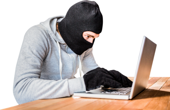 Focused thief with hood typing on laptop - Powered by Adobe