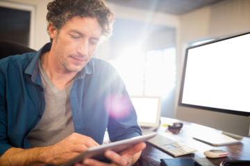 A businessman looking his tablet
