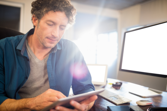 A businessman looking his tablet