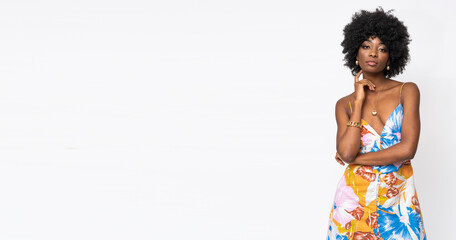 Fashionable African woman with curly hairs and floral dress on isolated white background.