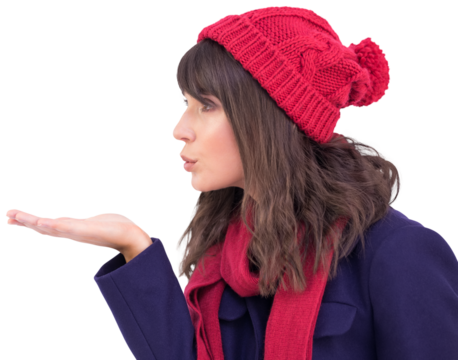 Festive brunette blowing a kiss