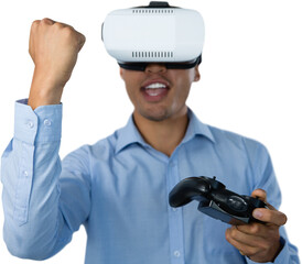Businessman with VR glasses clenching fist while playing video game