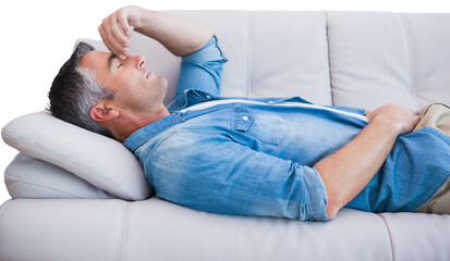 Obraz na płótnie Canvas Man suffering from headache while on sofa
