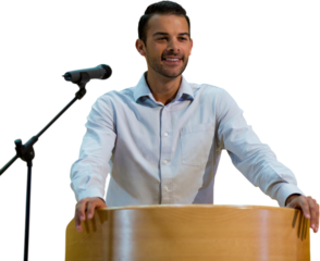 Smiling businessman giving speech at podium