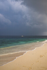 Fototapeta na wymiar beautiful exotic tropical beach and stormy clouds