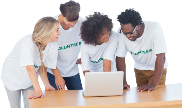 Smiling volunteers working together on a laptop