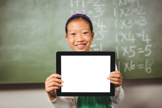 Girl holding digital tablet against greenboard