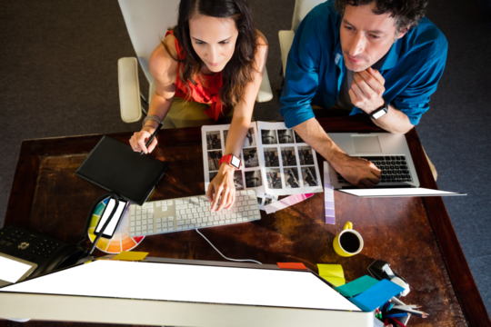 Colleagues using a graphic pad - Powered by Adobe