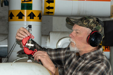 worker applying valve lockout