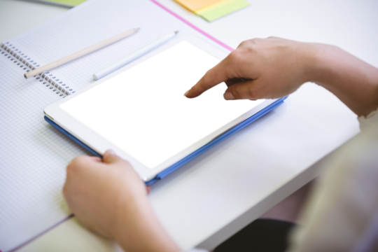 Cropped image of businesswoman touching digital tablet at office