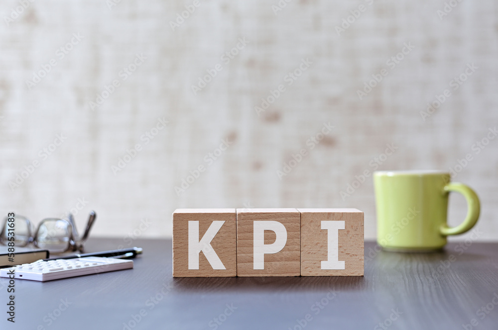 Poster there is wood cube with the word kpi. it is an acronym for key performance indicator an eye-catching