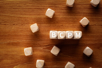 Fototapeta na wymiar There is wood cubes with the word BCPM. It is an abbreviation for Business Continuity Plan Management as eye-catching image.