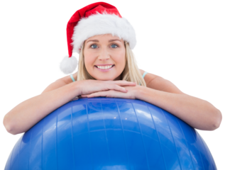 Festive fit blonde leaning on exercise ball
