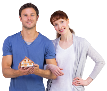Couple holding a model house