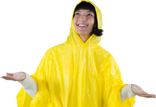 Woman in yellow raincoat gesturing to feel the rain - Powered by Adobe